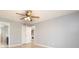 Open bedroom with a ceiling fan and showing the bathroom and laundry closets at 2725 N Poinciana Blvd # 147, Kissimmee, FL 34746