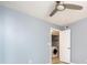 Bedroom with a ceiling fan showing the laundry closet with a washer and shelves inside at 2725 N Poinciana Blvd # 147, Kissimmee, FL 34746