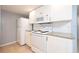 Bright kitchen equipped with white cabinetry, sleek appliances, and granite countertops at 2725 N Poinciana Blvd # 147, Kissimmee, FL 34746