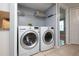 Convenient laundry area featuring a washer and dryer, with a glimpse of a bedroom at 2725 N Poinciana Blvd # 147, Kissimmee, FL 34746