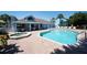 Community pool and hot tub with lounge chairs and covered seating areas provide a resort-like atmosphere at 2725 N Poinciana Blvd # 147, Kissimmee, FL 34746