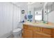 Neutral bathroom with framed mirror, framed art, and a patterned shower curtain at 2747 Lido Key Dr, Kissimmee, FL 34747