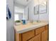 Neutral bathroom with a framed mirror, vanity with lots of storage, and wall decor at 2747 Lido Key Dr, Kissimmee, FL 34747