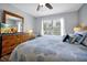 Serene bedroom with a ceiling fan, window, and wooden dresser with a TV on top at 2747 Lido Key Dr, Kissimmee, FL 34747