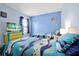 Comfortable bedroom featuring two twin beds with colorful bedding and a flat-screen television at 2747 Lido Key Dr, Kissimmee, FL 34747