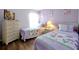 Charming bedroom featuring twin beds with floral bedding and a matching dresser with television at 2747 Lido Key Dr, Kissimmee, FL 34747