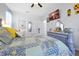 A cozy bedroom design with gray walls, sunflower art, ceiling fan, and carpeted floors at 2747 Lido Key Dr, Kissimmee, FL 34747