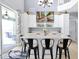 Kitchen island with bar stool seating and views to the backyard through sliding glass doors at 2747 Lido Key Dr, Kissimmee, FL 34747