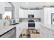 Bright kitchen with white cabinets, stainless steel appliances, and speckled granite countertops at 2747 Lido Key Dr, Kissimmee, FL 34747