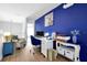 Bright home office featuring blue accent wall, white desk, and comfortable seating area at 2747 Lido Key Dr, Kissimmee, FL 34747