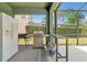 Covered patio features a BBQ grill and a refrigerator, creating an ideal outdoor cooking space at 2747 Lido Key Dr, Kissimmee, FL 34747