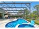Inviting screened pool with spa and multiple lounge chairs perfect for entertaining in the Florida sun at 2747 Lido Key Dr, Kissimmee, FL 34747
