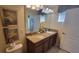 Elegant bathroom featuring a granite vanity with double sinks and decorative accents at 2952 Beach Palm Ave, Kissimmee, FL 34747