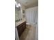 Well-lit bathroom featuring a granite countertop vanity, tile floors, and shower-tub combo at 2952 Beach Palm Ave, Kissimmee, FL 34747