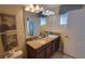 Elegant bathroom featuring a granite vanity with double sinks and decorative accents at 2952 Beach Palm Ave, Kissimmee, FL 34747