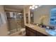 Well-lit bathroom with a glass-enclosed shower, a double-sink vanity, and modern fixtures, offering a spa-like experience at 2952 Beach Palm Ave, Kissimmee, FL 34747