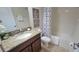 Well-maintained bathroom featuring a granite countertop and shower/tub combo at 2952 Beach Palm Ave, Kissimmee, FL 34747