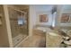 Bright bathroom featuring a glass-enclosed shower, soaking tub, and granite countertop vanity at 2952 Beach Palm Ave, Kissimmee, FL 34747