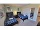 Modern twin beds with navy blue bedding and a matching nightstand at 2952 Beach Palm Ave, Kissimmee, FL 34747