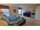 Comfortable bedroom featuring a queen bed, tv, and neutral decor at 2952 Beach Palm Ave, Kissimmee, FL 34747