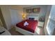 Cozy bedroom featuring a double bed, closet, and charming decor, perfect for relaxation at 2952 Beach Palm Ave, Kissimmee, FL 34747
