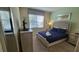 Cozy bedroom with a bed, stylish bedding, and natural light from the window at 2952 Beach Palm Ave, Kissimmee, FL 34747