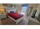 Comfortable bedroom featuring a double bed, dresser and window with natural light at 2952 Beach Palm Ave, Kissimmee, FL 34747