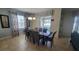 Open dining room with seating for six features a modern chandelier and natural light from the sliding glass door at 2952 Beach Palm Ave, Kissimmee, FL 34747