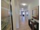 Inviting hallway with decorative mirror and tile floors, leading to other rooms at 2952 Beach Palm Ave, Kissimmee, FL 34747