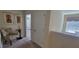 Upstairs hallway with chair and bedroom view, highlighting the home's layout and access to private spaces at 2952 Beach Palm Ave, Kissimmee, FL 34747