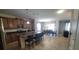 Open-concept kitchen with an island, sleek stainless steel appliances and adjacent dining area at 2952 Beach Palm Ave, Kissimmee, FL 34747