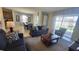Living room leading to the dining area and patio, featuring neutral paint and tiled floors, perfect for relaxation at 2952 Beach Palm Ave, Kissimmee, FL 34747
