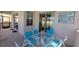 Covered outdoor patio with dining set, perfect for enjoying outdoor meals and relaxing in the shade at 2952 Beach Palm Ave, Kissimmee, FL 34747