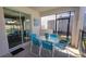 Covered patio with dining set, ideal for outdoor gatherings and relaxation with serene backyard views at 2952 Beach Palm Ave, Kissimmee, FL 34747