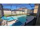 Inviting swimming pool with sun loungers, ideal for relaxation and enjoying the outdoors in style at 2952 Beach Palm Ave, Kissimmee, FL 34747