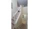 Carpeted staircase with white railings, providing a seamless transition between floors and enhancing the home's design at 2952 Beach Palm Ave, Kissimmee, FL 34747