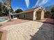 Backyard with hardscape, pool, and landscaping at 308 S Shadow Bay Dr, Orlando, FL 32825
