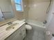 Full bathroom featuring a bathtub, toilet, and vanity sink with cabinets at 308 S Shadow Bay Dr, Orlando, FL 32825