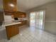 Kitchen area with oak cabinets, tile floors, lots of room, and a view to the outside patio with pool at 308 S Shadow Bay Dr, Orlando, FL 32825
