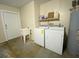 Utility room with washer, dryer, and utility sink at 308 S Shadow Bay Dr, Orlando, FL 32825