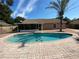 An in-ground pool surrounded by brick pavers in a private backyard at 308 S Shadow Bay Dr, Orlando, FL 32825