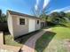 The backyard features a practical shed with a brick pathway, offering extra storage and convenience at 308 S Shadow Bay Dr, Orlando, FL 32825
