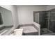 Bathroom featuring a sink, tub and standing shower with glass doors at 312 Nine Iron Dr, Davenport, FL 33896
