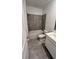 Modern bathroom featuring gray tiled walls, a shower-tub combination, a toilet, and a vanity at 312 Nine Iron Dr, Davenport, FL 33896