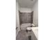 Modern bathroom featuring gray tiled walls, a shower-tub combination, a toilet, and a vanity at 312 Nine Iron Dr, Davenport, FL 33896