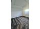 This spacious bedroom features plush gray carpeting and a tray ceiling, complemented by a bright window at 312 Nine Iron Dr, Davenport, FL 33896