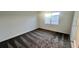 Bright bedroom with gray carpet and a window at 312 Nine Iron Dr, Davenport, FL 33896