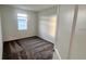 Small bedroom with gray carpet and a window at 312 Nine Iron Dr, Davenport, FL 33896