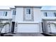 Attractive townhome featuring a two car garage, stone facade, and well manicured landscaping at 312 Nine Iron Dr, Davenport, FL 33896