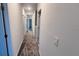 A carpeted hallway leads to various rooms in the home, showcasing neutral wall color at 312 Nine Iron Dr, Davenport, FL 33896